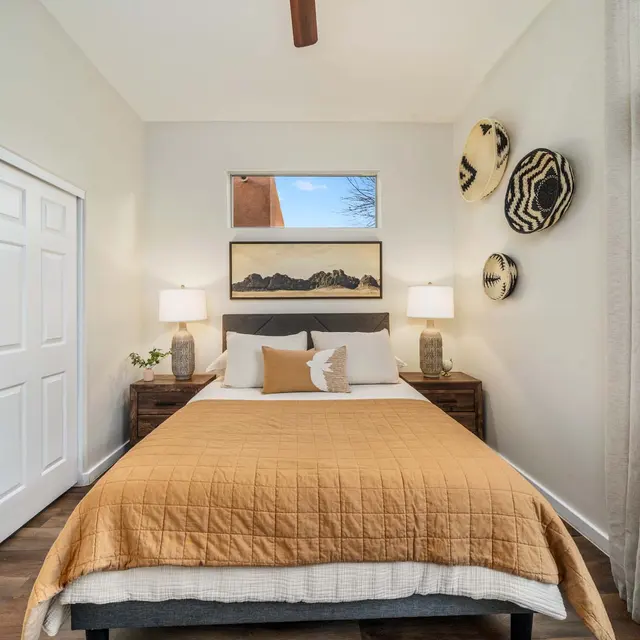 Cozy bedroom with ceiling fan and window views at Avilla Marana detached rental homes