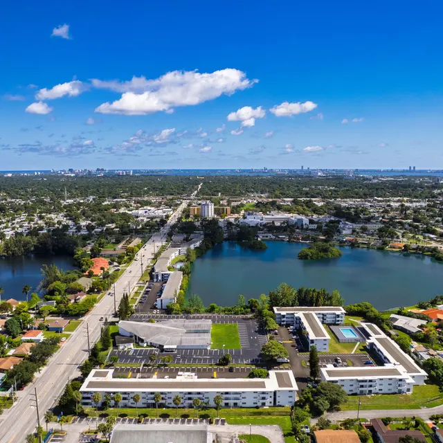 Aerial view of a suburban area in Miami featuring lakes, residential buildings, and roads.