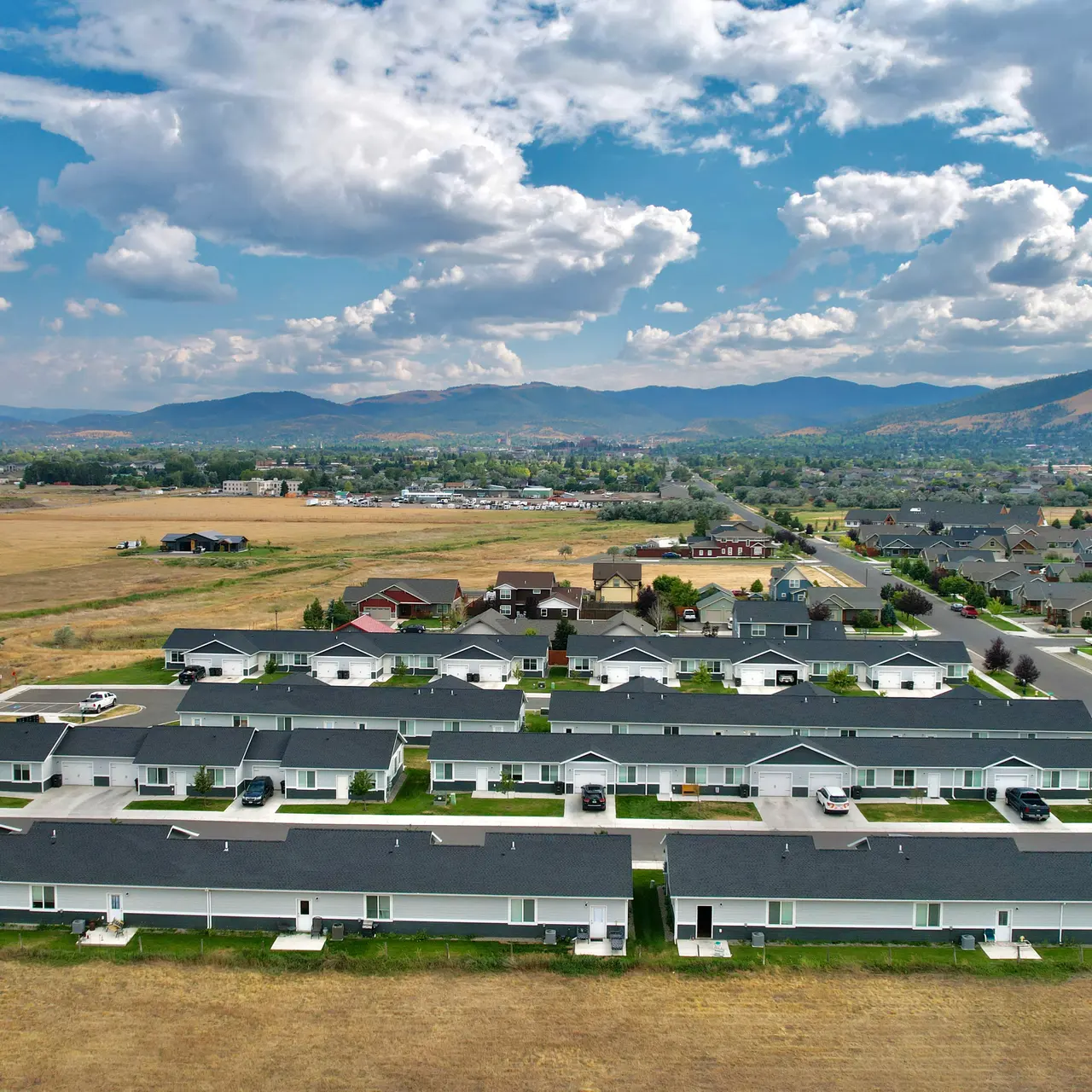 apartment aerial view Aerial view of Elkhorn Flats apartment complex in Helena, MT, showcasing its layout and surrounding environment, including mountains