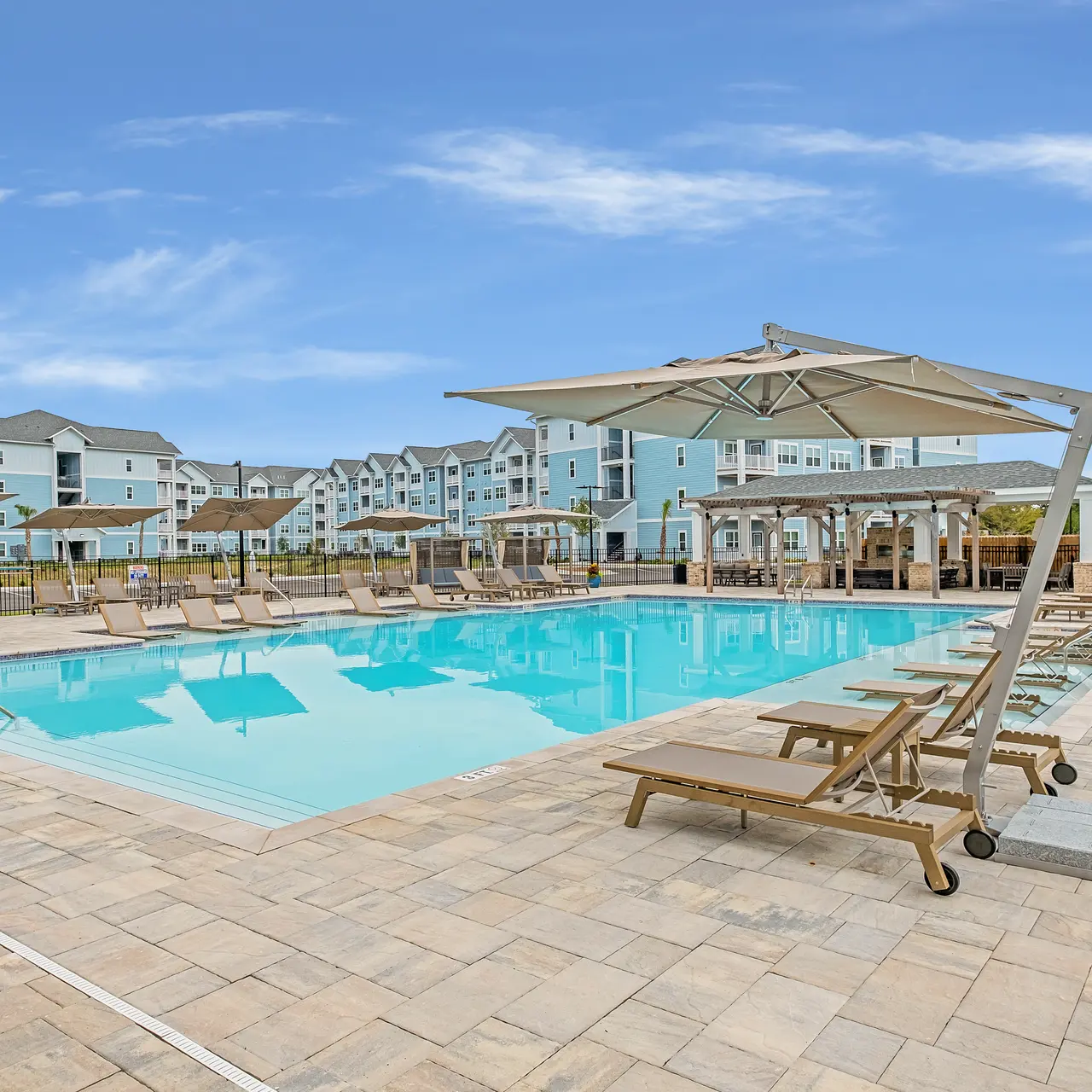 large swimming pool with lounge seating