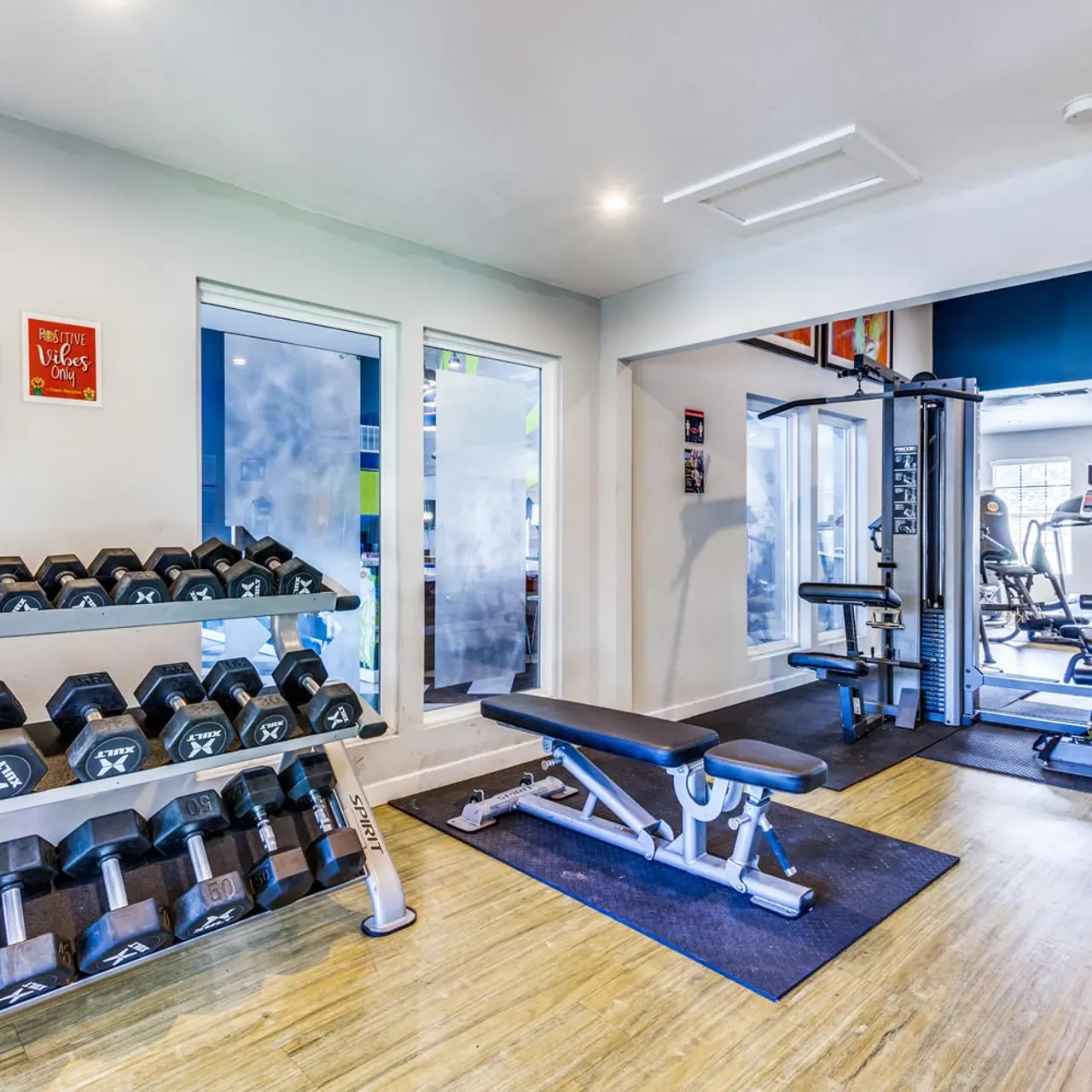 Balcones Club Apartments - Fitness Center with weights and equipment