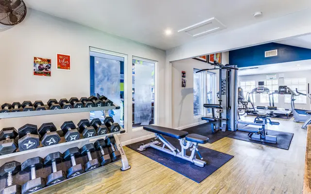 Balcones Club Apartments - Fitness Center with weights and equipment 