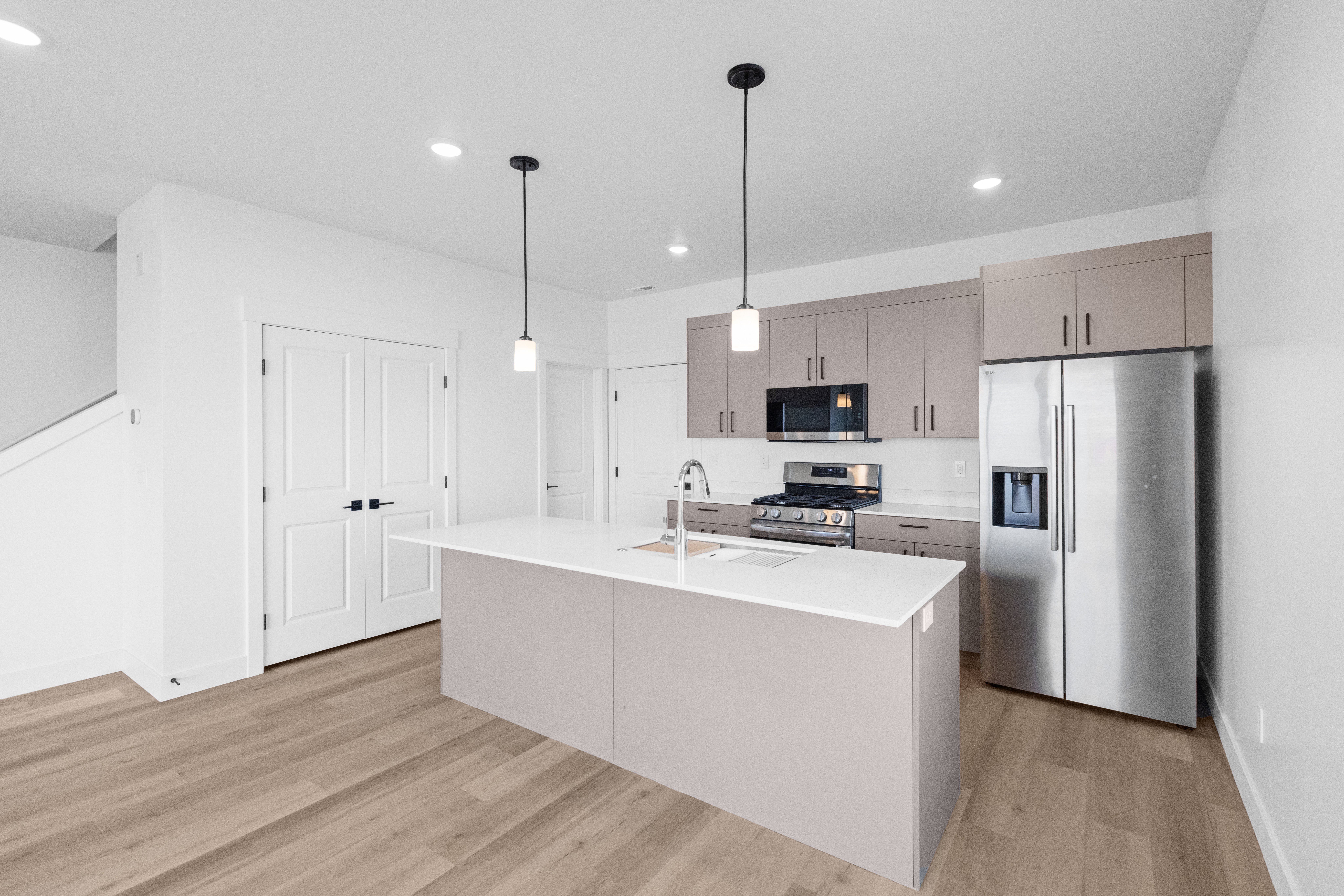 Contemporary Kitchen Interior A modern kitchen featuring a large island, stainless steel appliances, and light wood flooring.