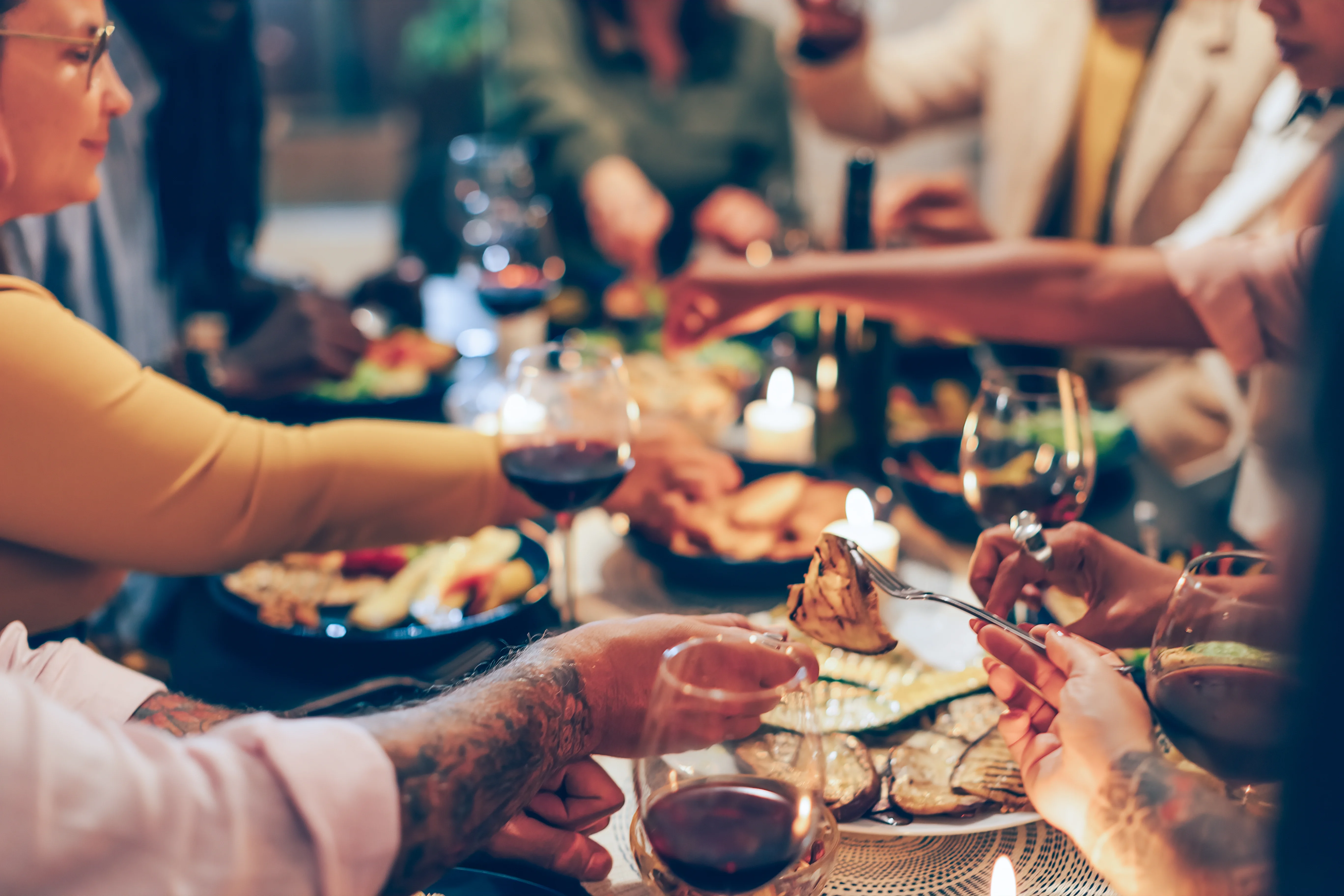 Dinner Party Celebration People enjoying a lively dinner party with food, wine, and conversation.