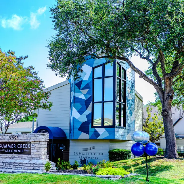 Exterior view of Summer Creek Apartments building with modern architecture