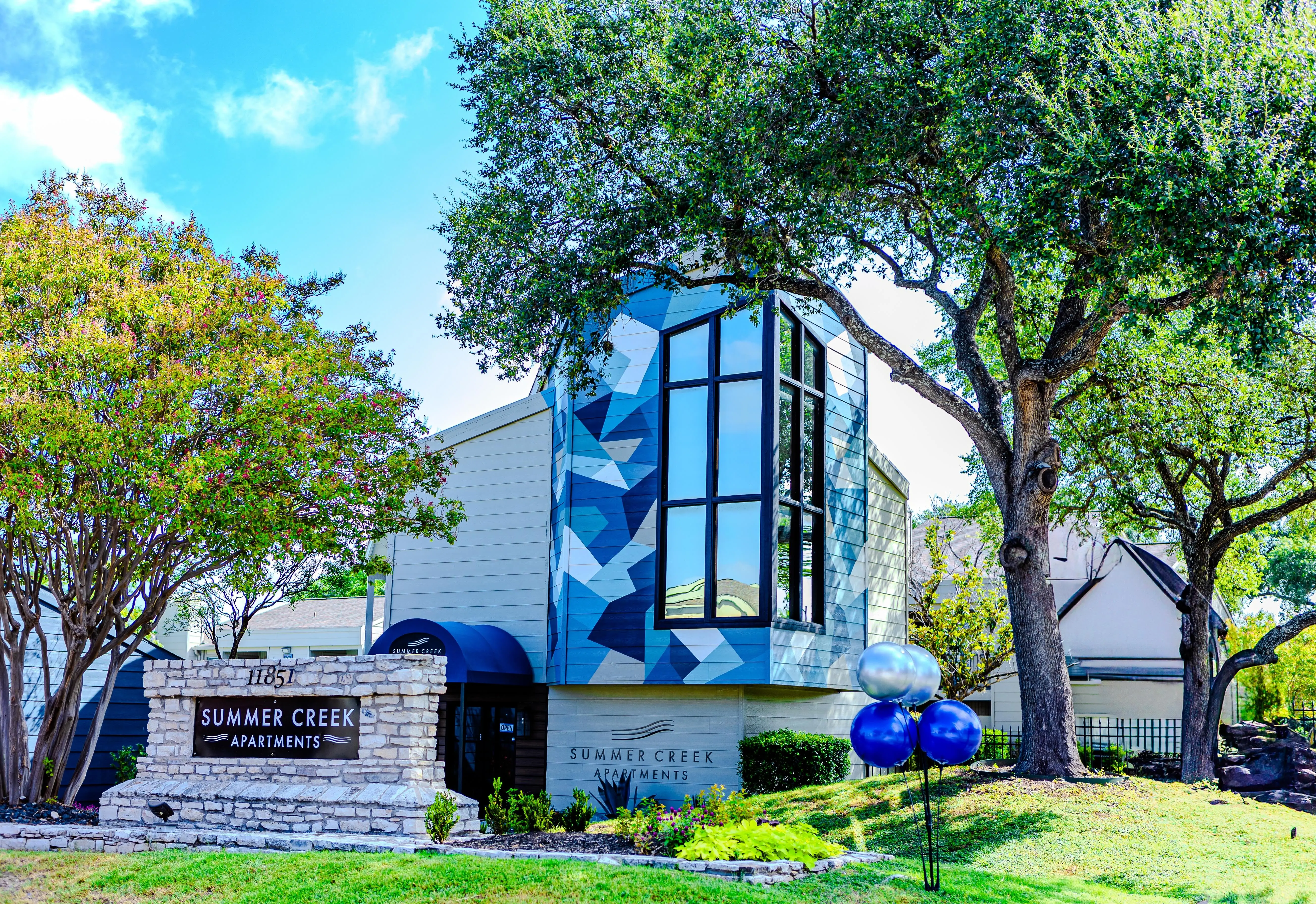 Exterior view of Summer Creek Apartments building with modern architecture