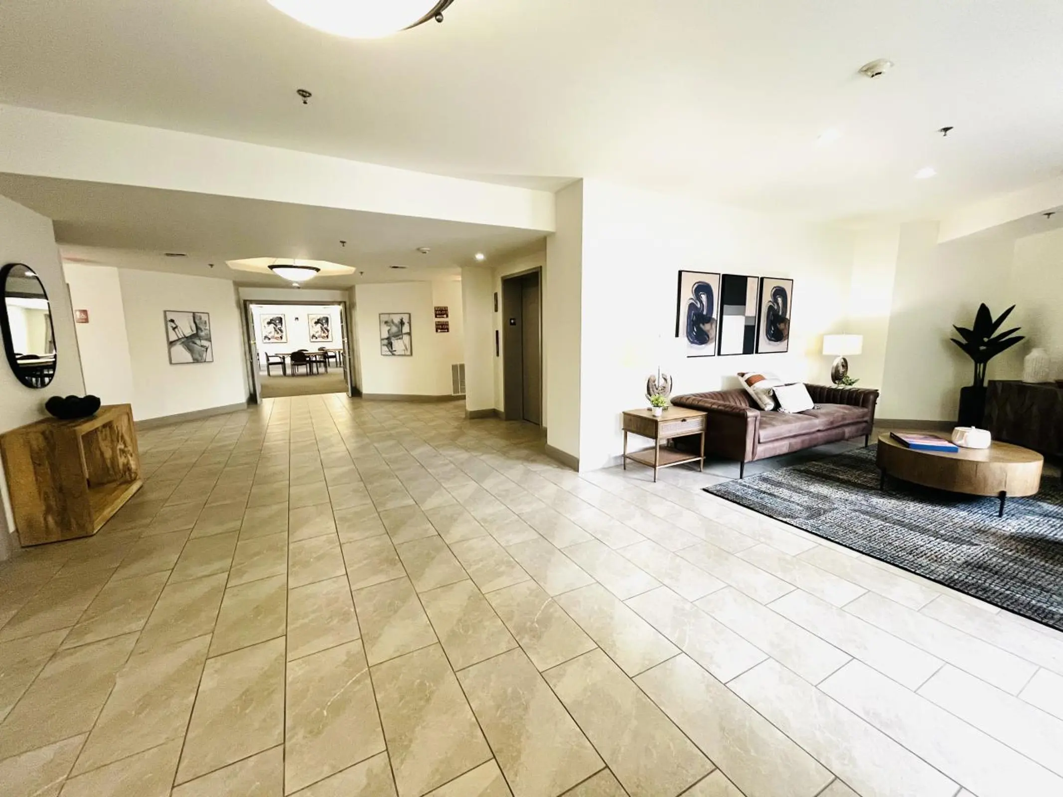 Tiled lobby with seating area and corridor.