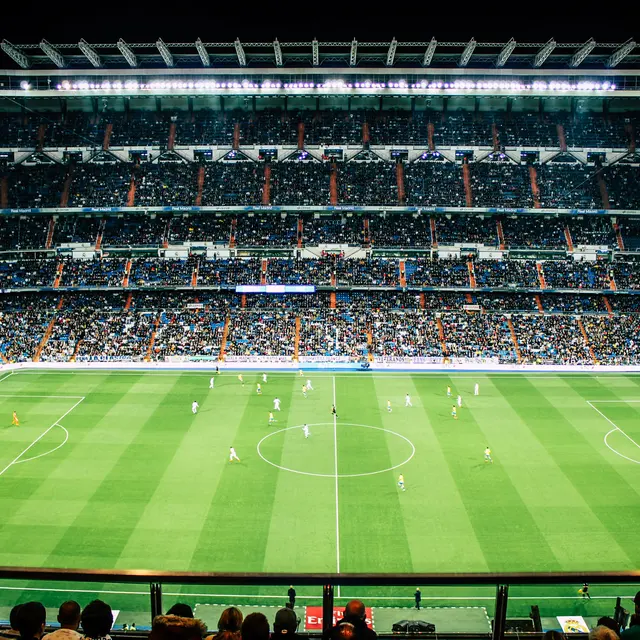 A panoramic view of a football stadium filled with fans during a match.