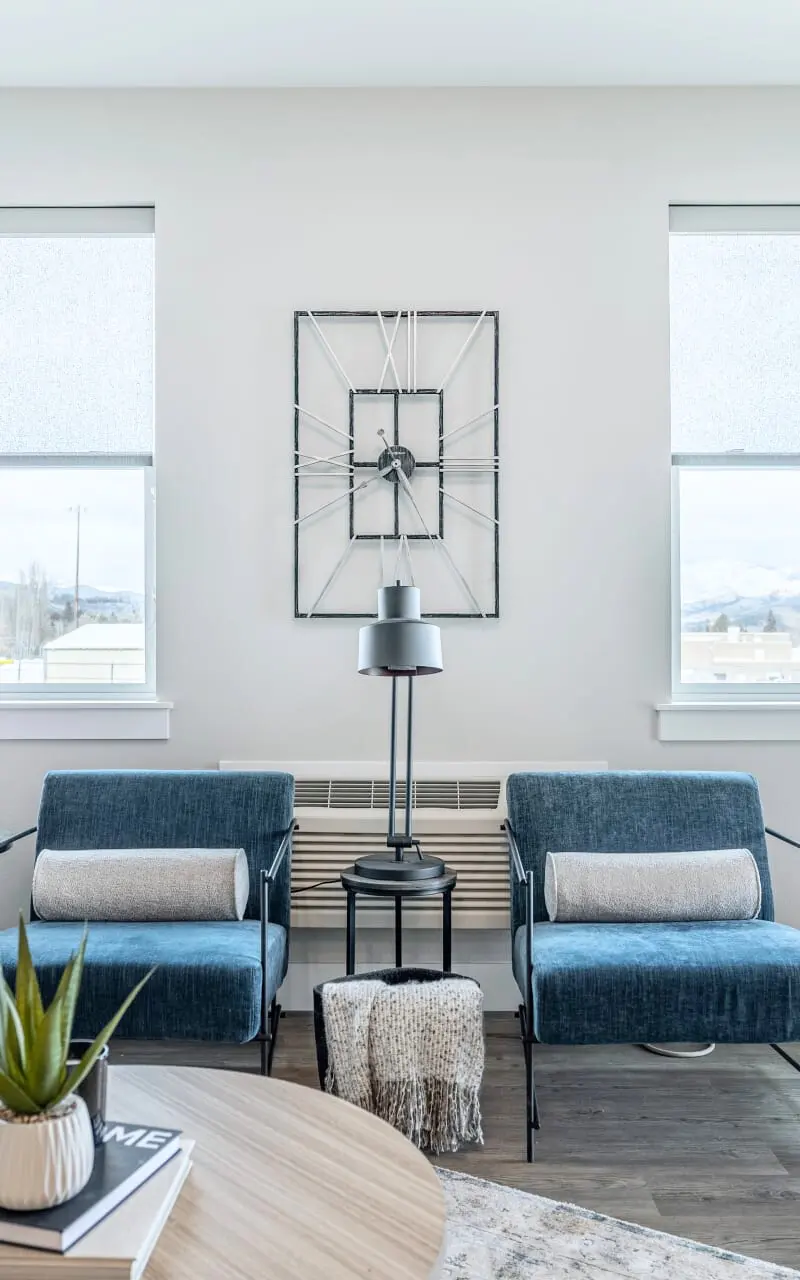 A spacious living room in the apartment, furnished with a couch, chairs, and elegant decor, offering a comfortable and inviting setting 