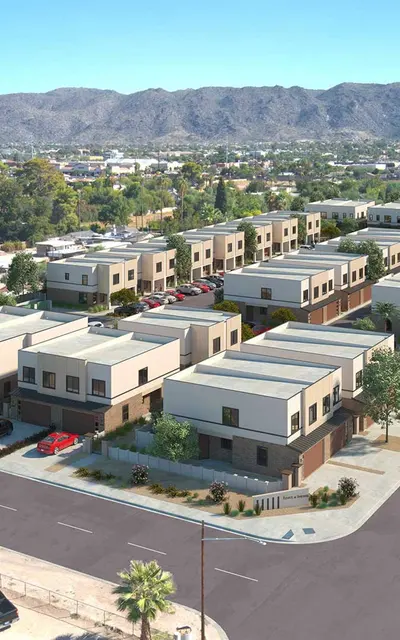 exterior-community-exterior-raymond-place-south-phoenix-az-apartments Pet-Friendly Townhouses in South Phoenix AZ - Raymond Place - Community Exterior and Surrounding Neighborhood, in a Tranquil Suburb, with Landscaping, Tan and White Walls, and with Mountains in the Distance