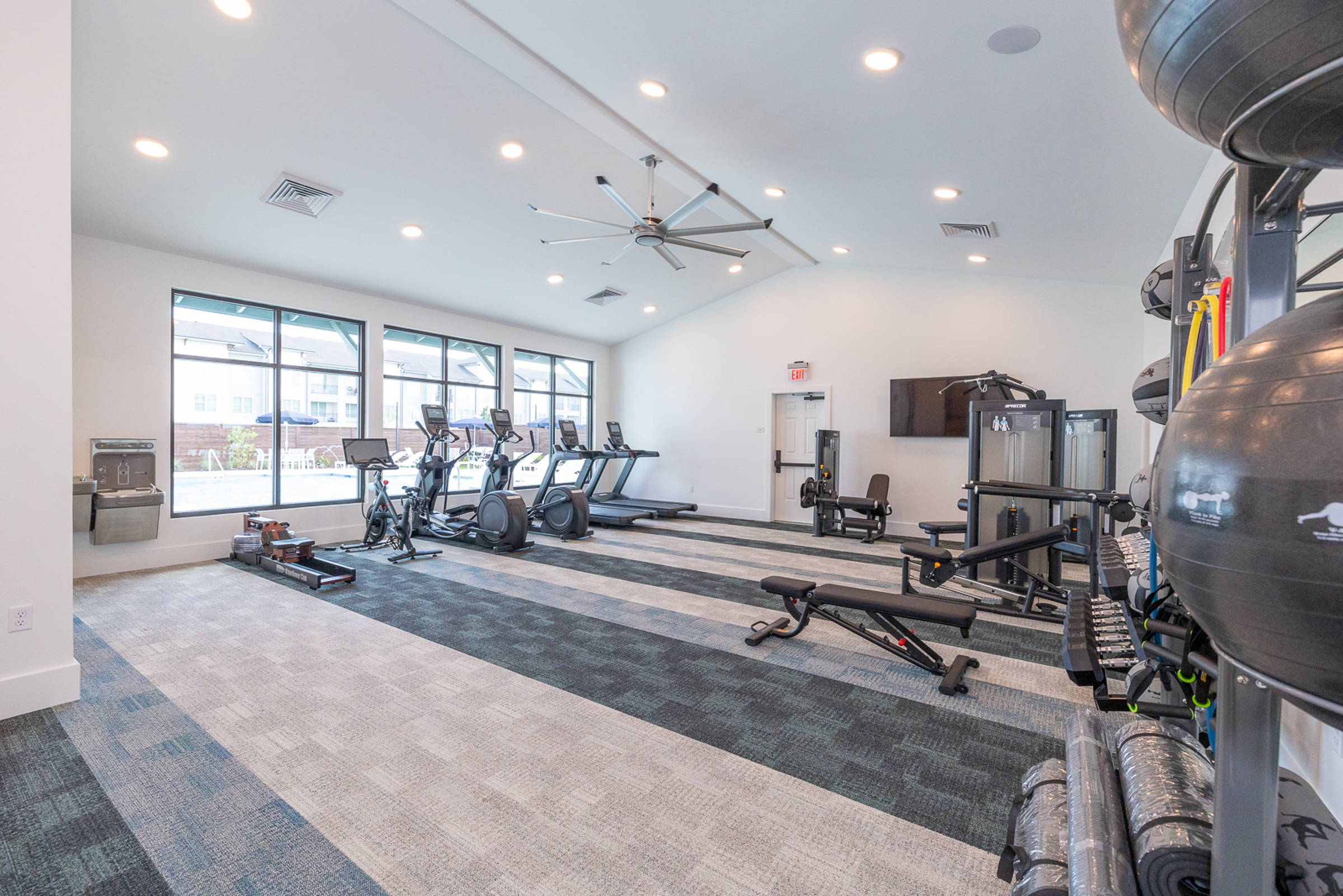 Spacious Modern Gym Interior Modern gym interior featuring exercise equipment and large windows for natural light.