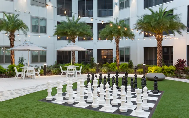 Exterior of Satori Town Center Apartments in Jacksonville FL - Grass, Chess, Game