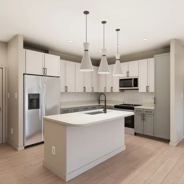 A modern kitchen featuring white cabinets, stainless steel appliances, and pendant lights. The kitchen island includes a sink, and there is a doorway leading to another room.