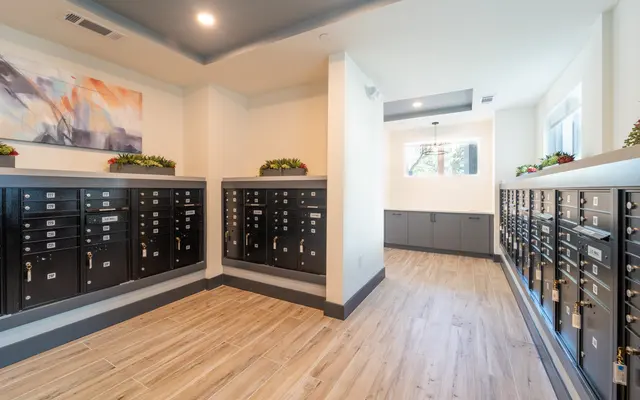 A modern mailroom with wall-mounted locking mailboxes