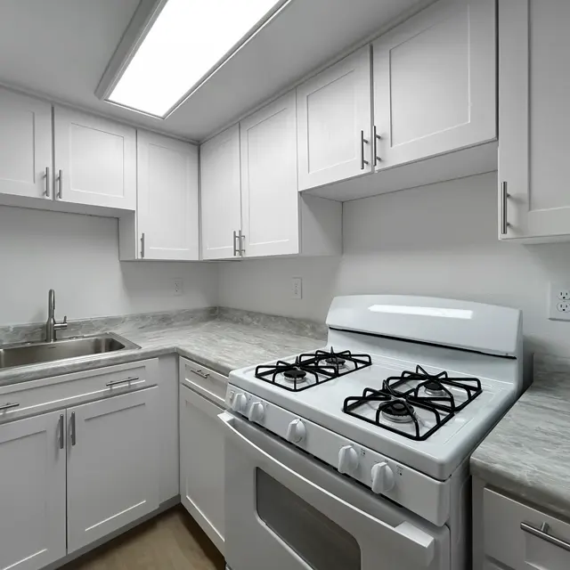 Modern Kitchen Interior A modern kitchen featuring white cabinetry and a gas stove with a stainless steel sink.