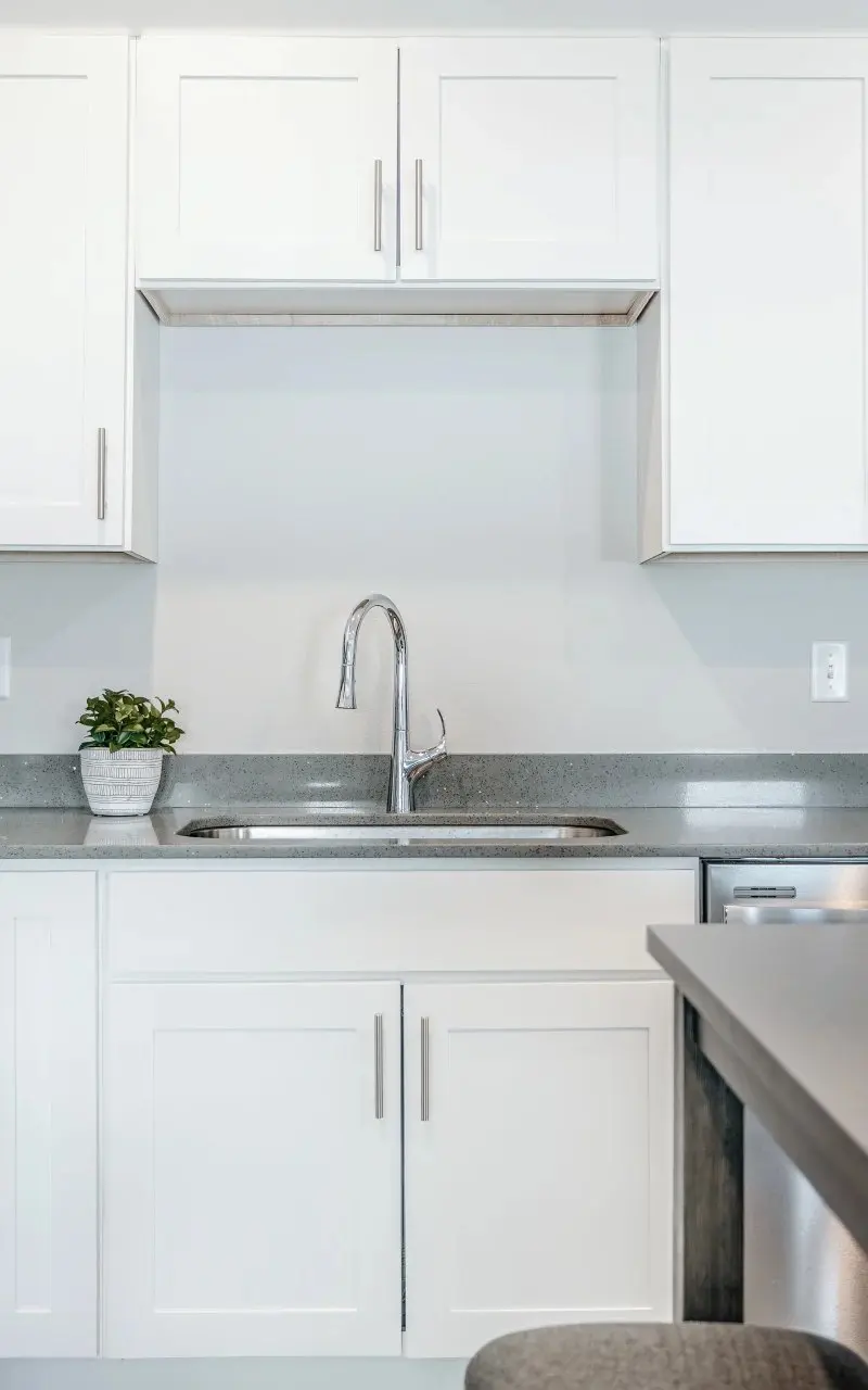 Modern kitchen in an apartment with stainless steel appliances and stylish finishes