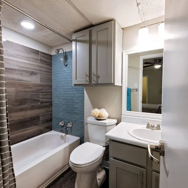 Artisan at South Lamar Furnished bathroom with large vanity mirror, tub, and overhead lighting at Artisan at South Lamar in Austin, TX
