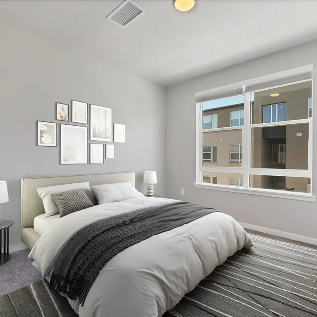 Contemporary Bedroom Design Modern bedroom with a large bed, decorative wall art, side tables, and windows showcasing external view.