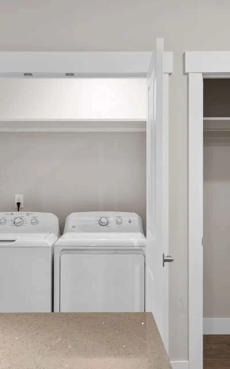 The front view of a modern washer and dryer set in a laundry room