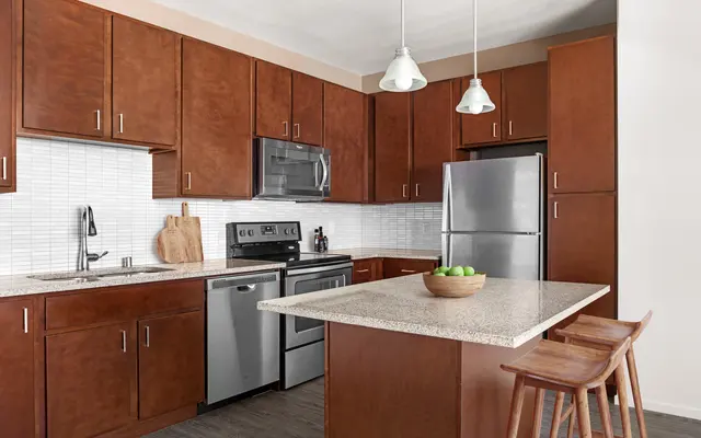 corner angle of kitchen, brown cabinet, stainless-steel appliances at apartments in Kapolei, HI - Room, Indoors, Kitchen