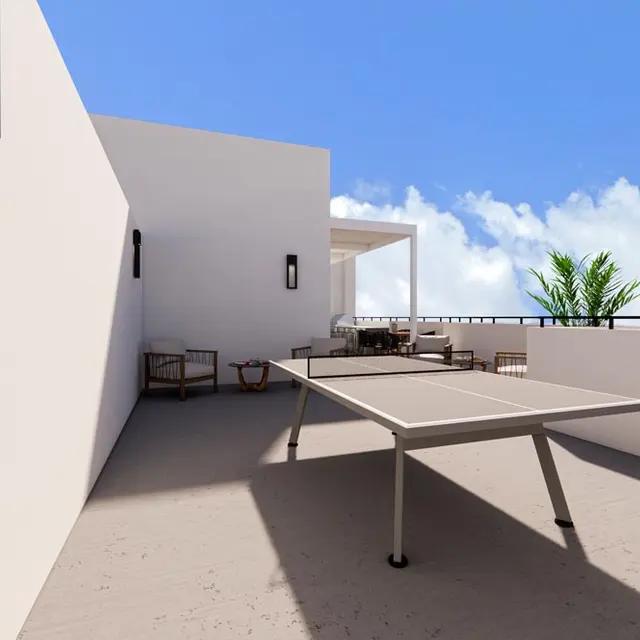 Balcony or terrace area featuring a table tennis table with seating arrangements in the background and blue skies with white clouds above.
