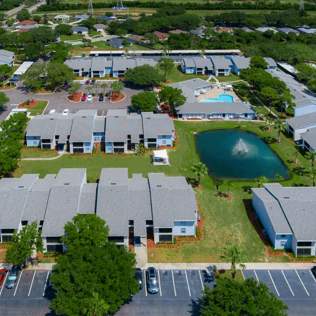 Aerial view of Portofino Club Luxury Apartment community in Jacksonville, FL featuring buildings and parking lots.