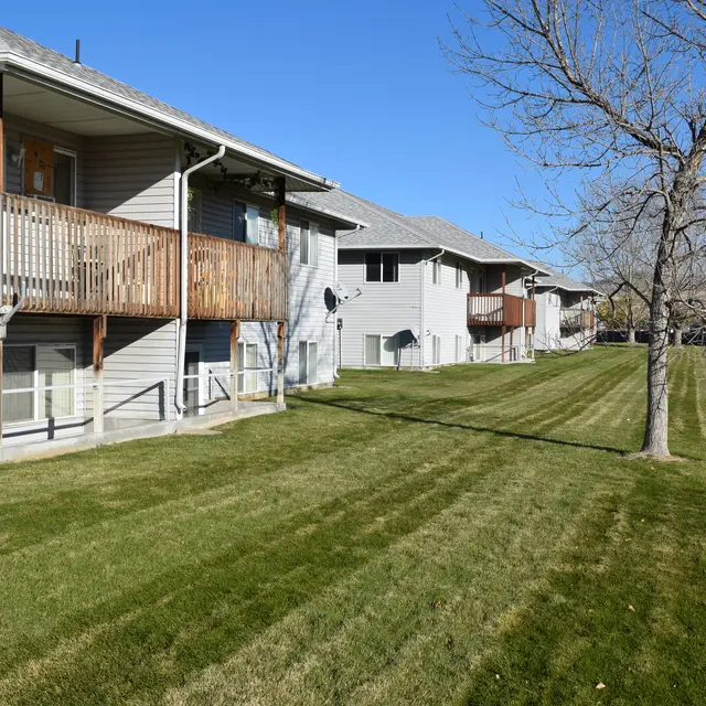 Apartment Complex with Lawn View of an apartment complex with a well-maintained lawn and balconies on the side.