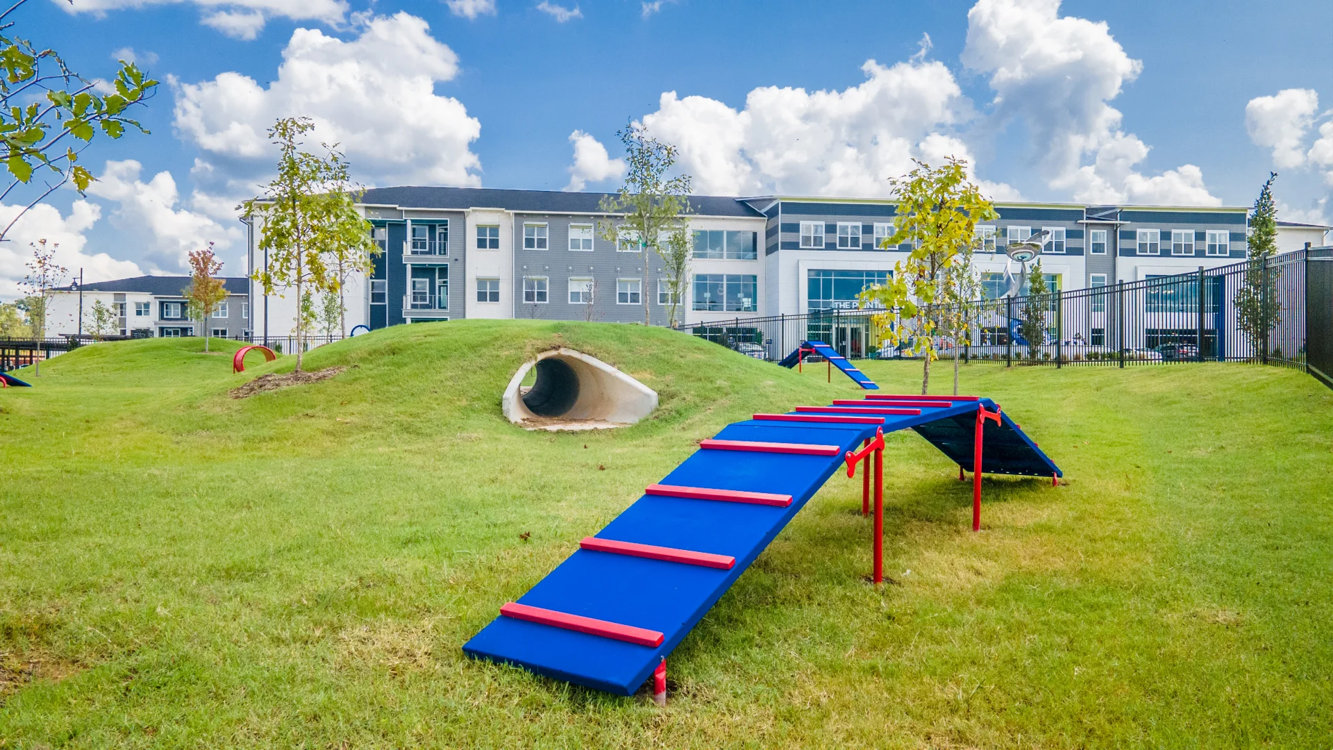 Photo of the agility course obstacles and tunnels in the dog park at The Pointe North Hills in North Little Rock, Arkansas.