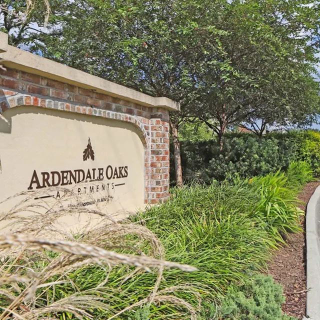 Sign for Ardendale Oaks Apartments surrounded by greenery.