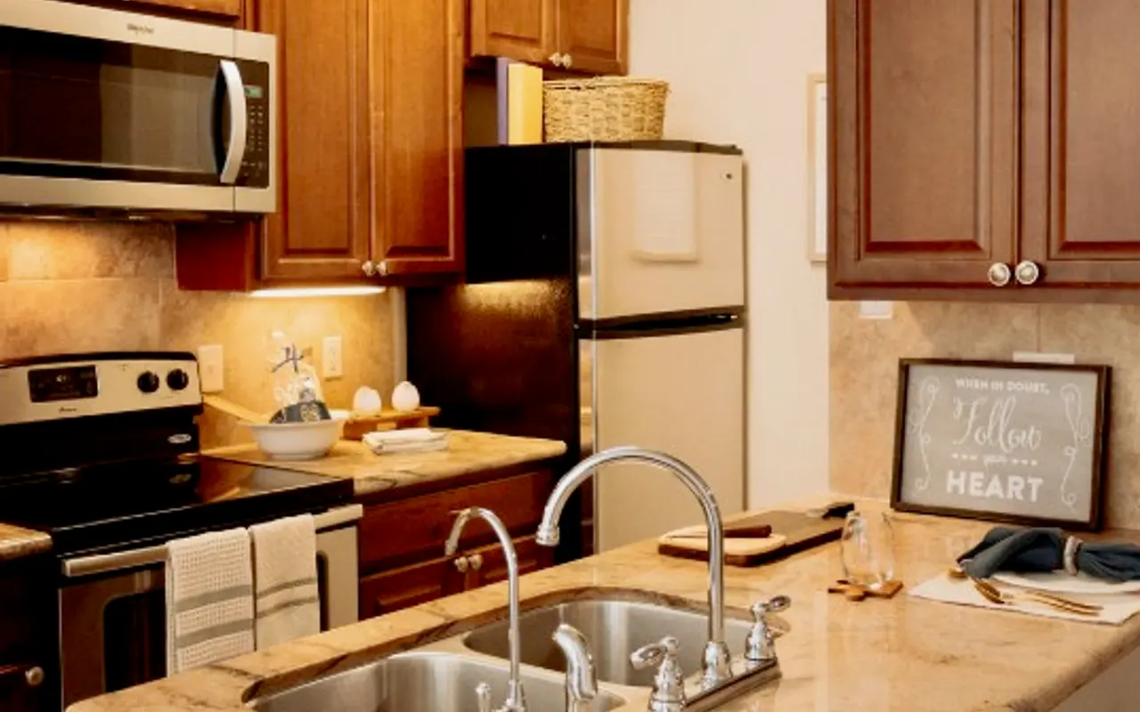 Stylish Modern Kitchen A contemporary kitchen featuring wooden cabinets, granite countertops, stainless steel appliances, and a double sink with modern faucets.