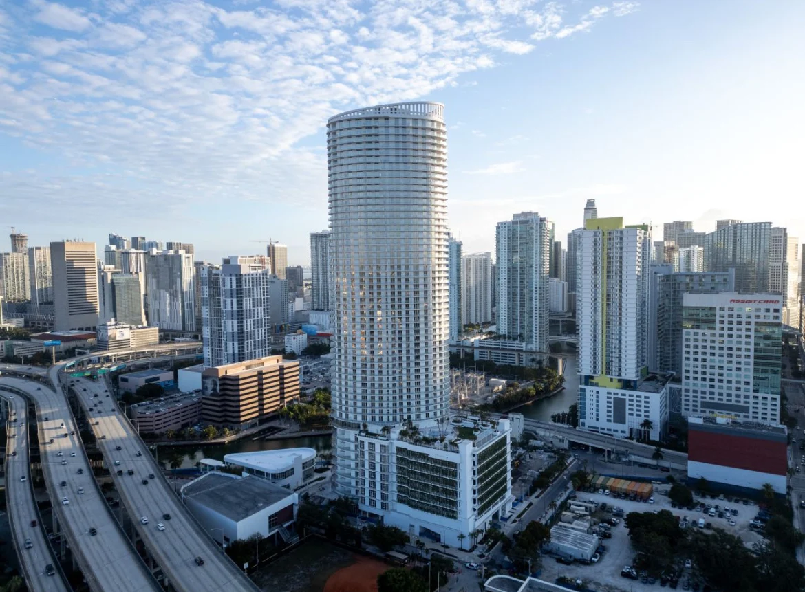 Aerial View of Miami Skyline Aerial view of a modern city skyline in Miami, showcasing high-rise buildings and highways.