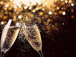 Two champagne glasses clinking together with sparkling bubbles, set against a dark background with golden bokeh lights.
