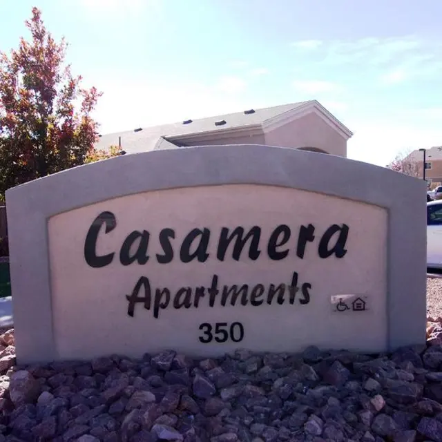Casamera Apartments Sign Sign for Casamera Apartments displaying the number 350, surrounded by rocks and plants.