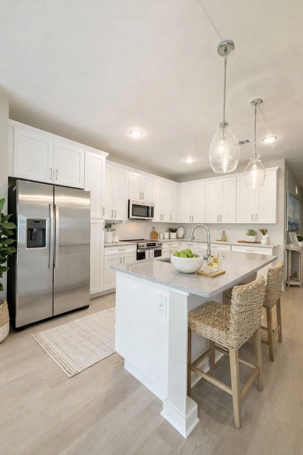 Contemporary Kitchen Design A modern kitchen featuring white cabinets, stainless steel appliances, and a central island with bar stools.