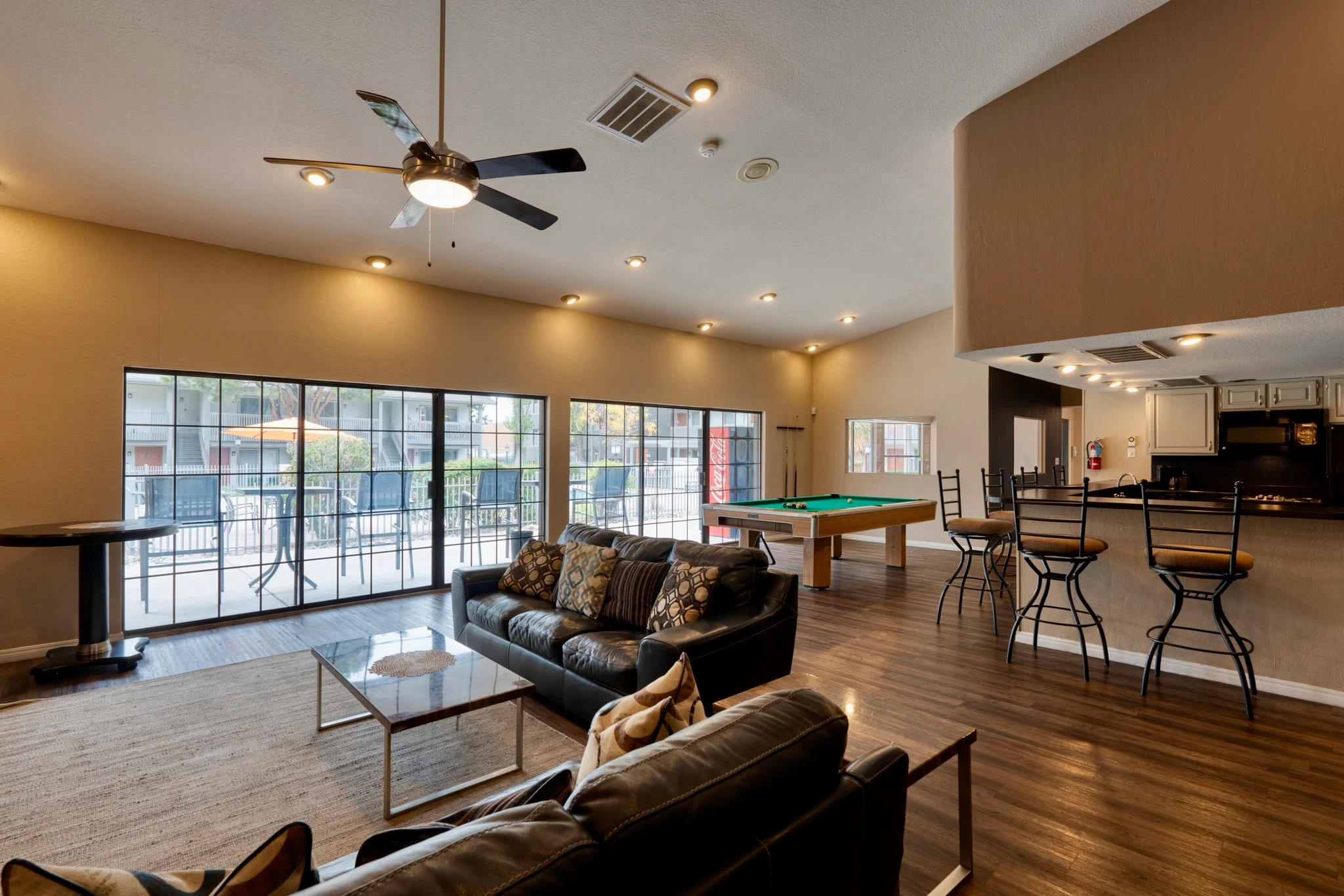 Modern Community Lounge A spacious community lounge area with large windows, comfortable seating, and a billiard table.