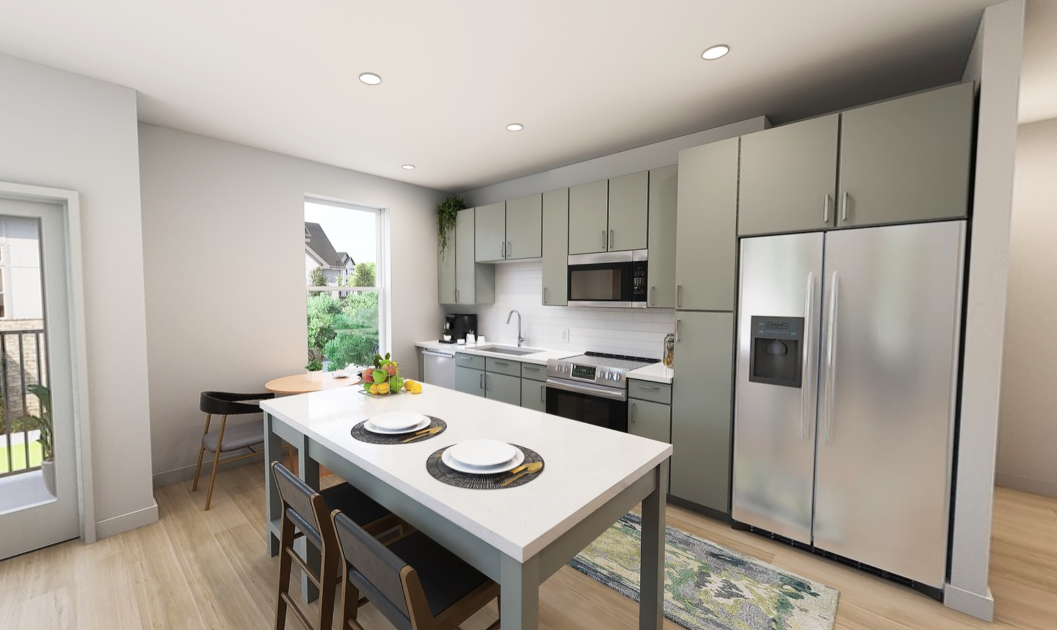 A modern kitchen featuring gray cabinets, a stainless steel refrigerator, and a white countertop with two plates set on it. There is a small dining table with a chair and a door leading outside.