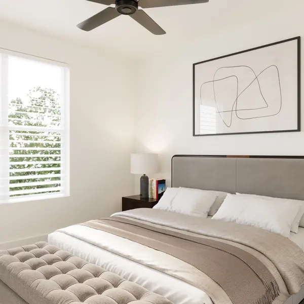 Modern Bedroom Design A modern bedroom featuring a large bed with a grey upholstered headboard, beige bedding, and two bedside tables with lamps. There's a window with white shutters letting in natural light, and a decorative plant in the corner.