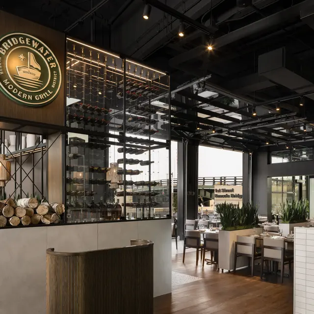 The Bridgewater Interior of a modern restaurant featuring a wine display, wooden elements, and contemporary decor.