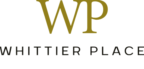 Whittier Place Logo Logo of Whittier Place featuring stylized initials WP in gold and the full name in black.