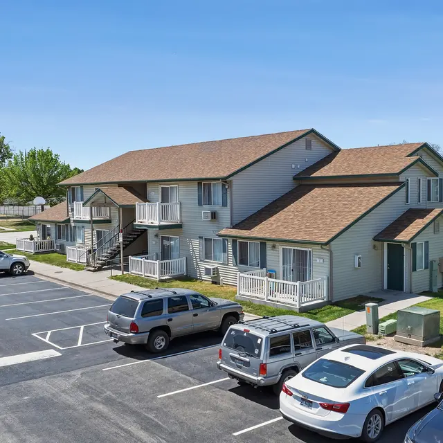 Aerial View of Apartment Complex Aerial view of an apartment complex with two-story buildings and a parking lot full of cars.