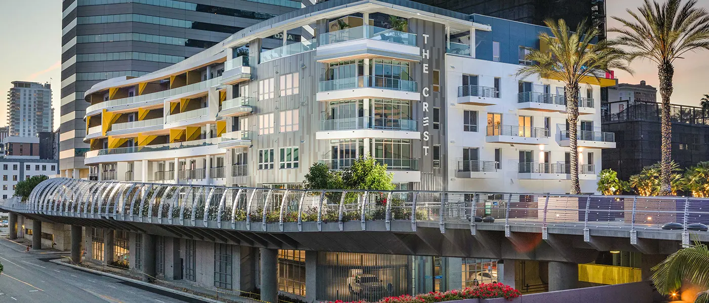 Modern apartment building with balconies and palm trees