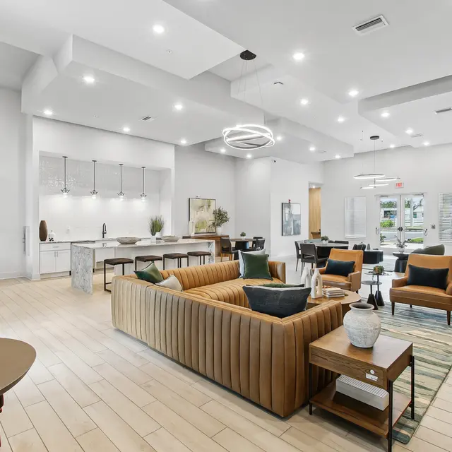 Modern lobby area with stylish seating, contemporary decor, and bright overhead lighting. Features a cozy, inviting atmosphere.