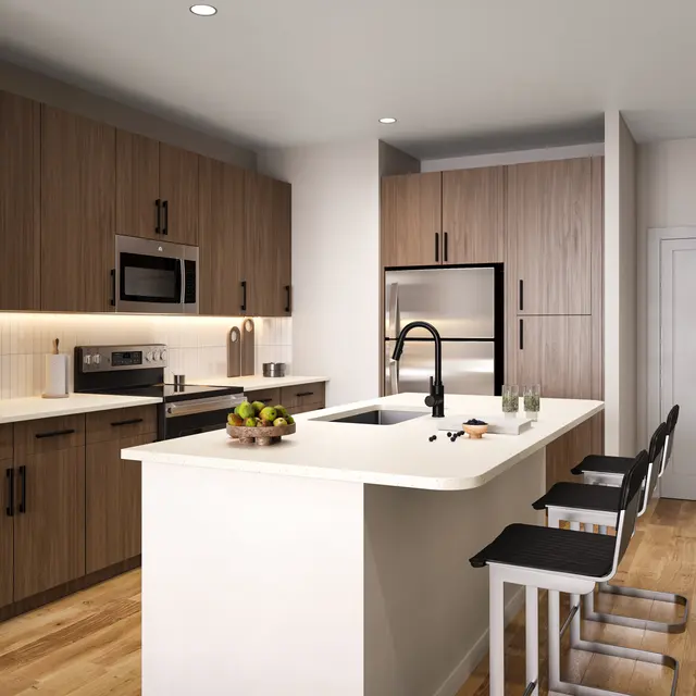 A modern kitchen featuring wooden cabinetry, stainless steel appliances, an island with seating, and a bright, clean look.