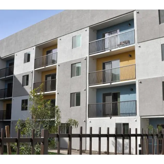 Modern Apartment Building Exterior Exterior view of a modern apartment building with balconies and colorful accents.