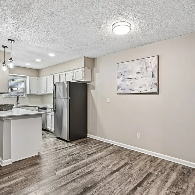 Modern Kitchen Interior Contemporary kitchen interior with wooden flooring, white cabinetry, and stainless steel appliances.