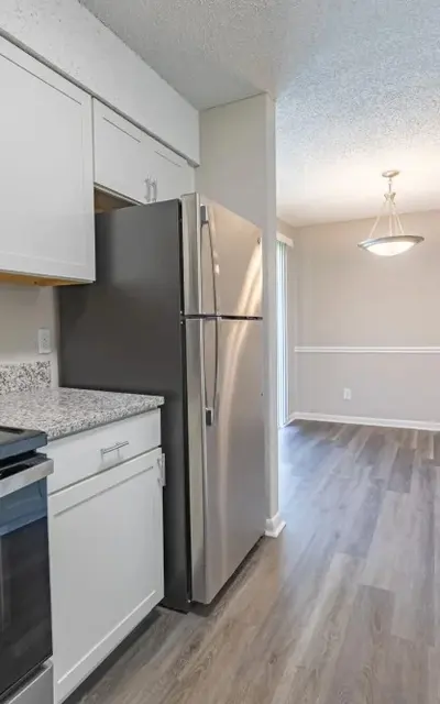 Modern kitchen with stainless steel appliances and granite countertops.