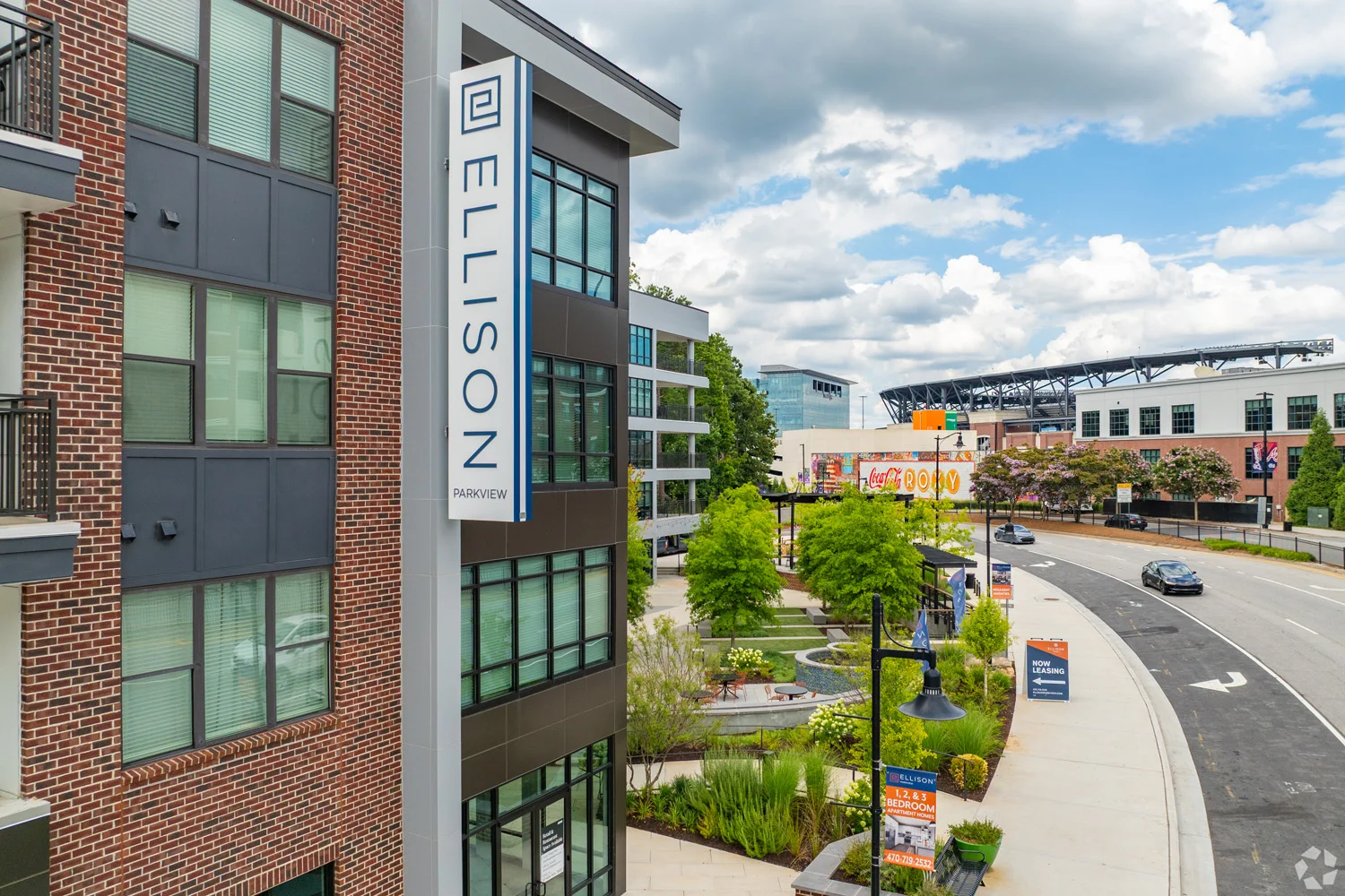 Modern Apartment Building - ELLISON Exterior view of a modern apartment building named 'ELLISON' with landscaped gardens and a road in the foreground.