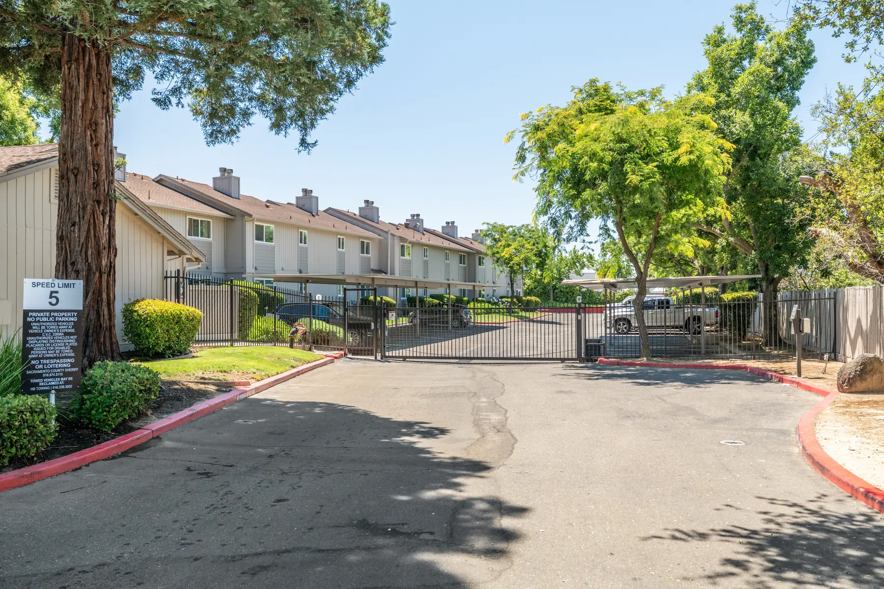 Entrance to a gated community with multi-family housing.