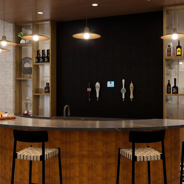 A modern bar with a curved wooden countertop, high chairs, pendant lighting, and shelves displaying bottles.
