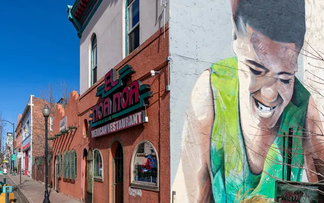 CULTURE ON EVERY CORNER Vibrant street view featuring a Mexican restaurant with a prominent mural of a smiling person on the adjacent wall. The sky is clear and blue, creating a lively atmosphere.